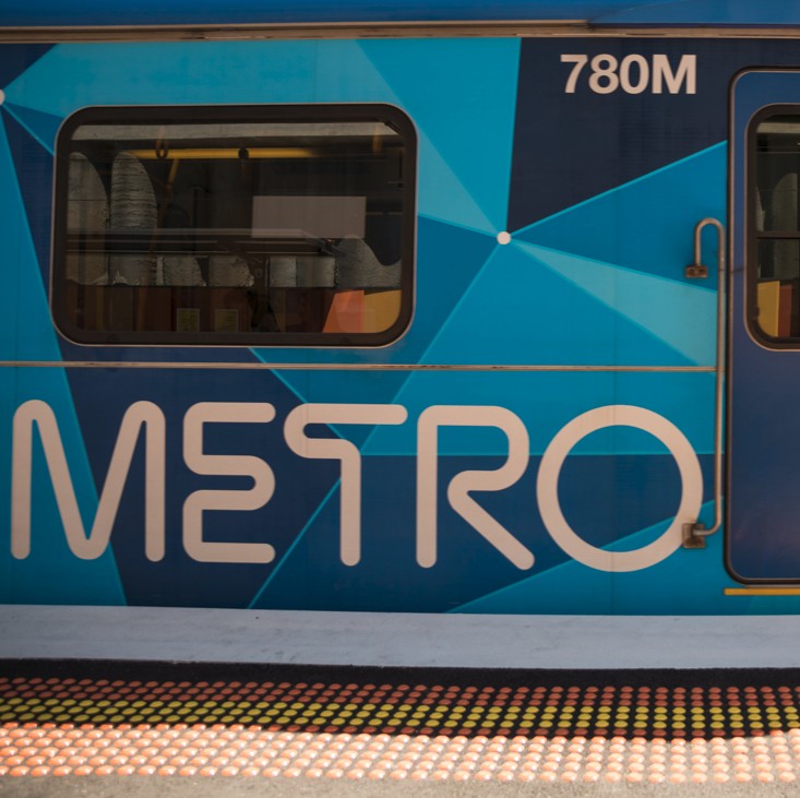 a close up photo of a train stationed at a platform. Metro is written on the side.