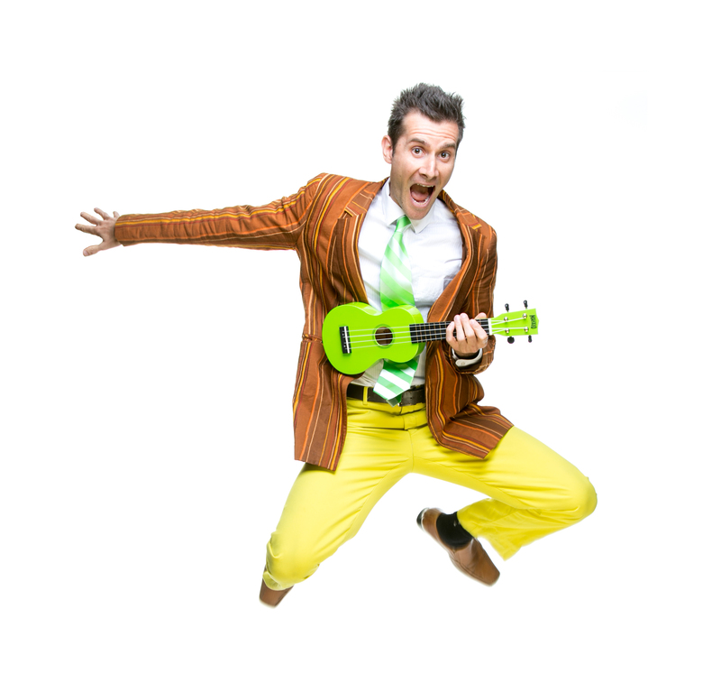 Man jumping up with a guitar and looking excited