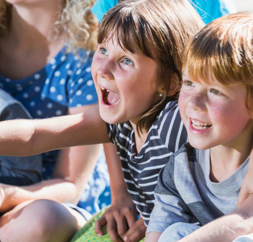 Photo of two children looking ahead and laughing