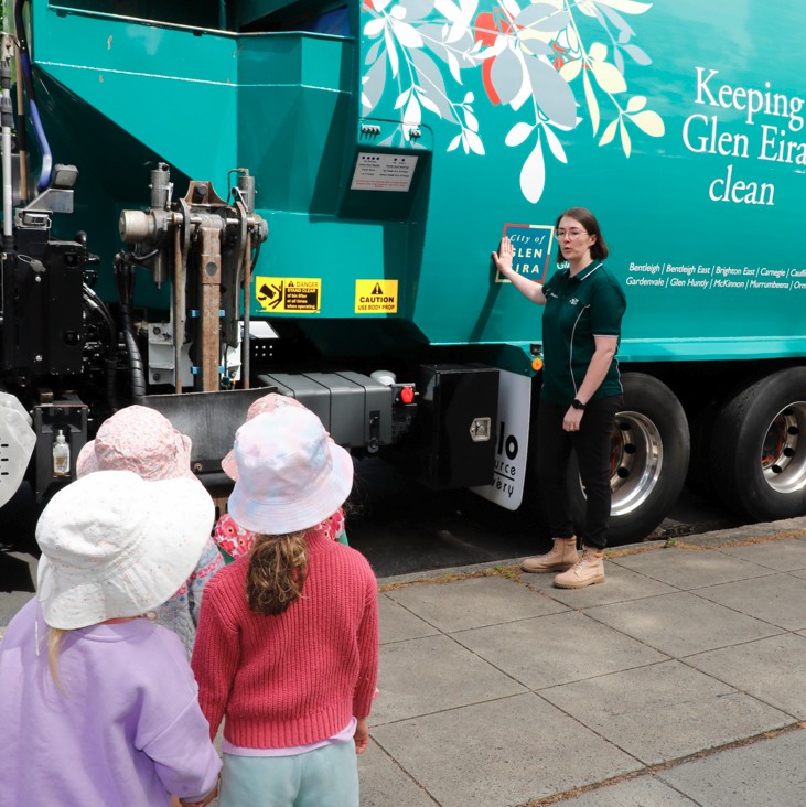 four children standing in front of a Glen Eira recycling truck.
